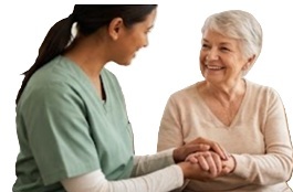 Two Indian caregivers discussing patient status during a shift handover at home